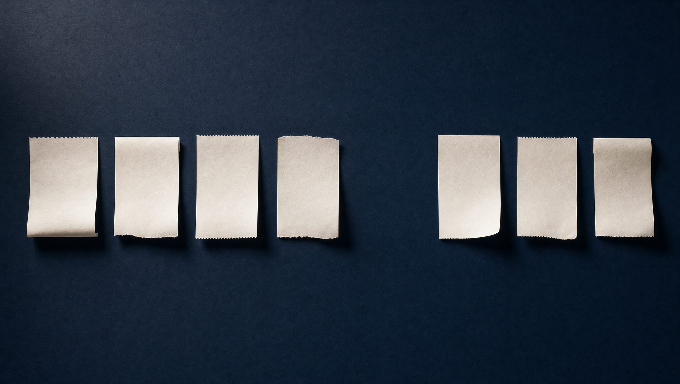 Seven blank paper receipts in a row on a dark navy surface, with one slot empty, marked $612.40, no receipt.